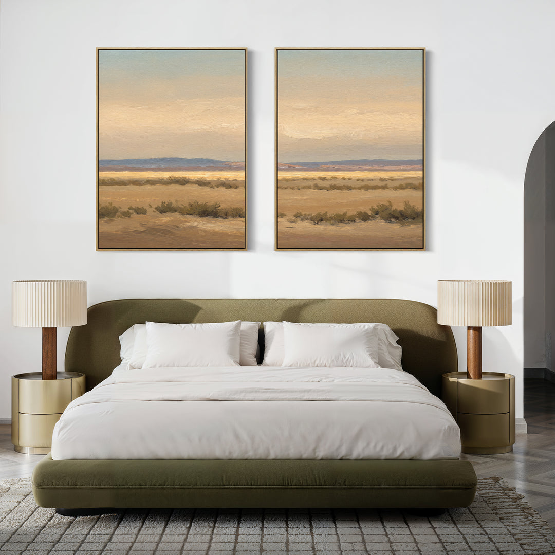 A modern bedroom with an olive green upholstered bed, white bedding, two round nightstands with beige lamps, and the "Desert Solitude - Set of 2" southwestern landscape canvases above the bed on a white wall.