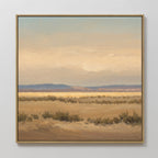 Desert Solitude Canvas Art - Square features a framed canvas print of a calm desert landscape with low bushes, distant mountains, and soft clouds in warm, muted tones—ideal southwestern art for serene wall decor.