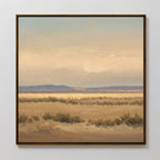 Desert Solitude Canvas Art - Square features a framed print of an open desert with dry bushes, distant hills, and soft clouded skies. Muted earth tones add calm, making it perfect wall decor for fans of southwestern landscape art.