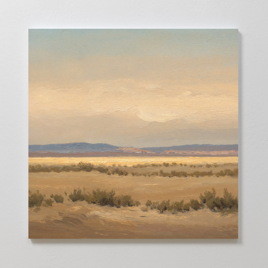 Desert Solitude Canvas Art - Square features a painted southwestern landscape with flat desert, low shrubs, distant hills, and a soft, cloudy sky in beige and blue—ideal serene wall decor for a calm, expansive atmosphere.