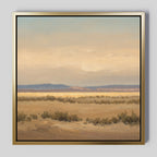 Desert Solitude Canvas Art - Square features a serene southwestern landscape with dry shrubs, distant mountains, and a pastel sky. The gold frame with black inner border makes this wall decor perfect for any space.