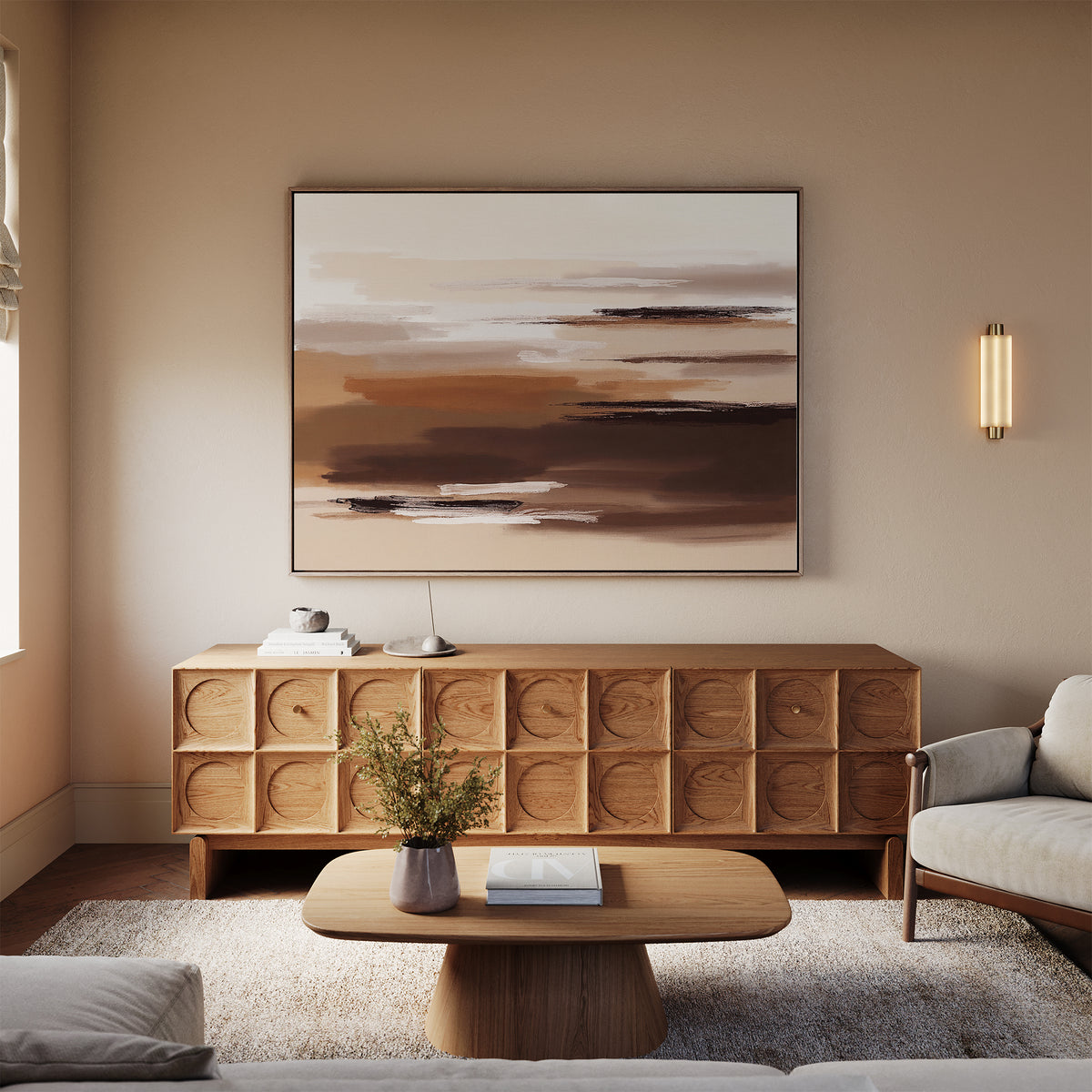A modern living room with neutral tones showcases a light wood sideboard with circular patterns, a matching coffee table, beige sofa, textured rug, and the Desert Winds Canvas Art - Horizontal on the wall.