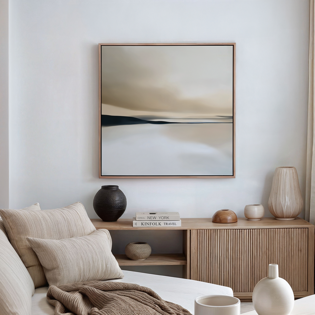 A modern, minimal living room features neutral-toned furniture and the Desert Quietude Abstract Canvas Art in earthy hues above a beige couch—perfect inspiration for stylish living room decor.
