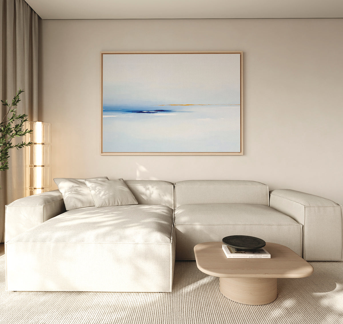 A modern living room with a light beige sectional sofa, a low wooden coffee table with a black bowl, neutral walls, floor-to-ceiling curtains, and Distant Archipelago Canvas Art - Horizontal adding blue and yellow contemporary accents.