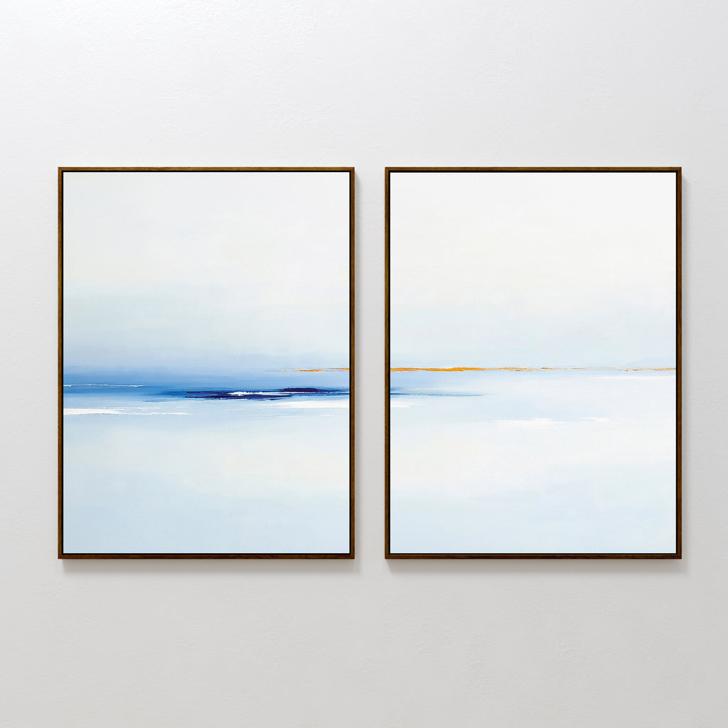 The Distant Archipelago - Set Of 2 features abstract, framed prints in soft blue, white, and tan tones side by side—ideal contemporary wall art for minimalist or Nordic Park-inspired interiors seeking a tranquil seascape vibe.
