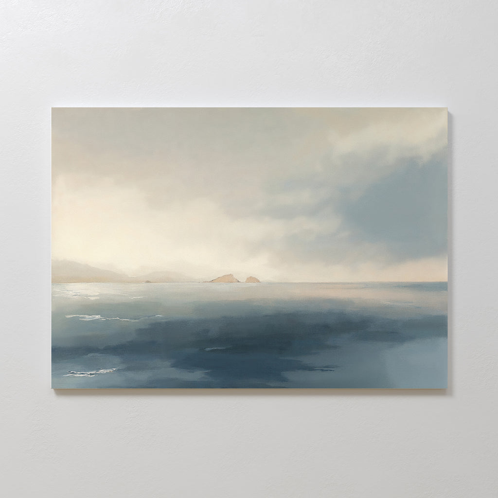 Distant Isles Canvas Art - Horizontal features a serene seascape with hazy islands and a soft cloudy sky in muted blue and beige tones, bringing tranquil home decor to any space.