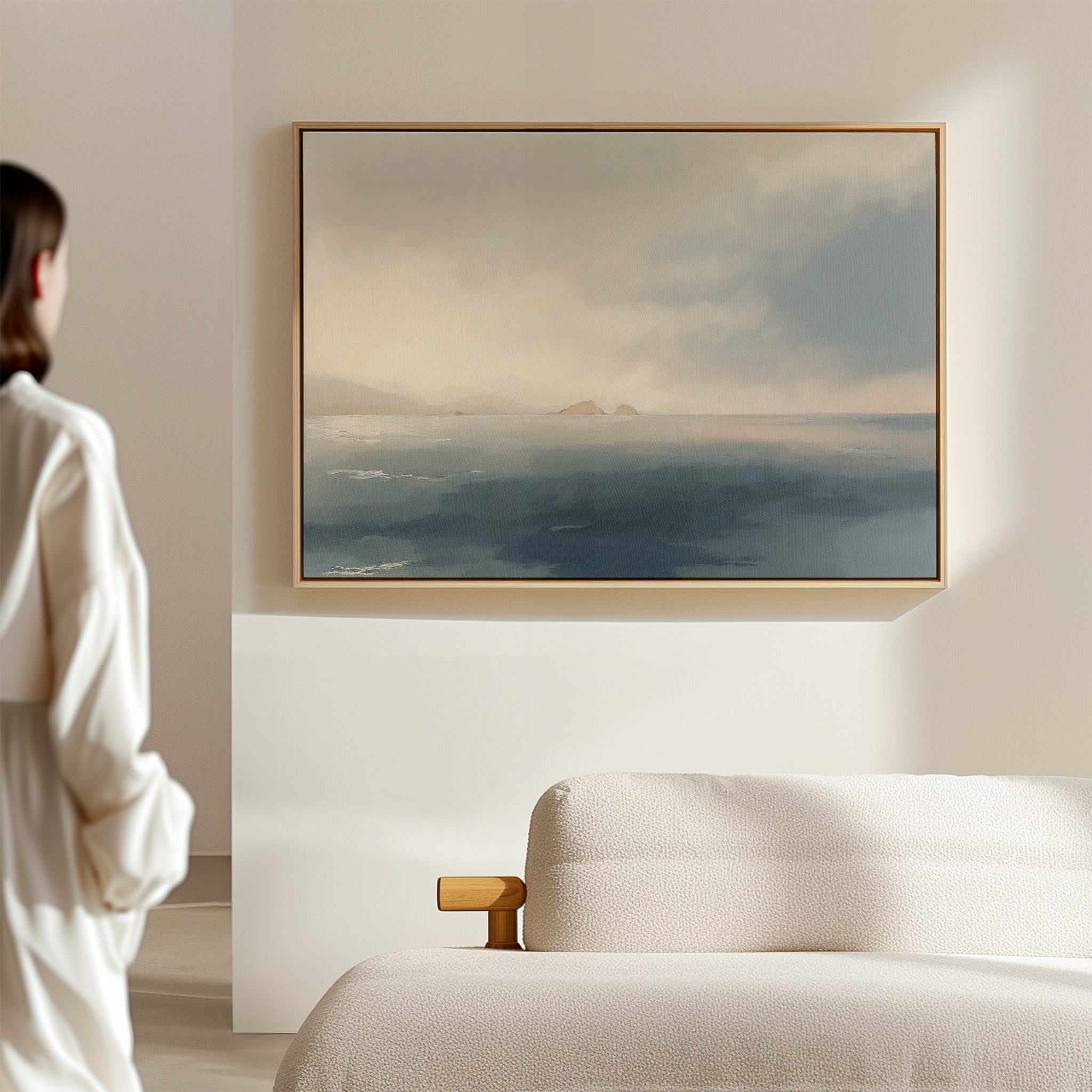 A woman gazes thoughtfully at the Distant Isles Canvas Art - Horizontal, adding a touch of tranquil home decor to her space.