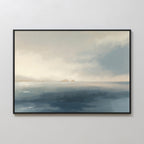 The Distant Isles Canvas Art - Horizontal displays a calm sea and distant mountains under a cloudy sky in soft blue and beige tones, creating a minimalist seascape perfect for tranquil home decor on light-colored walls.