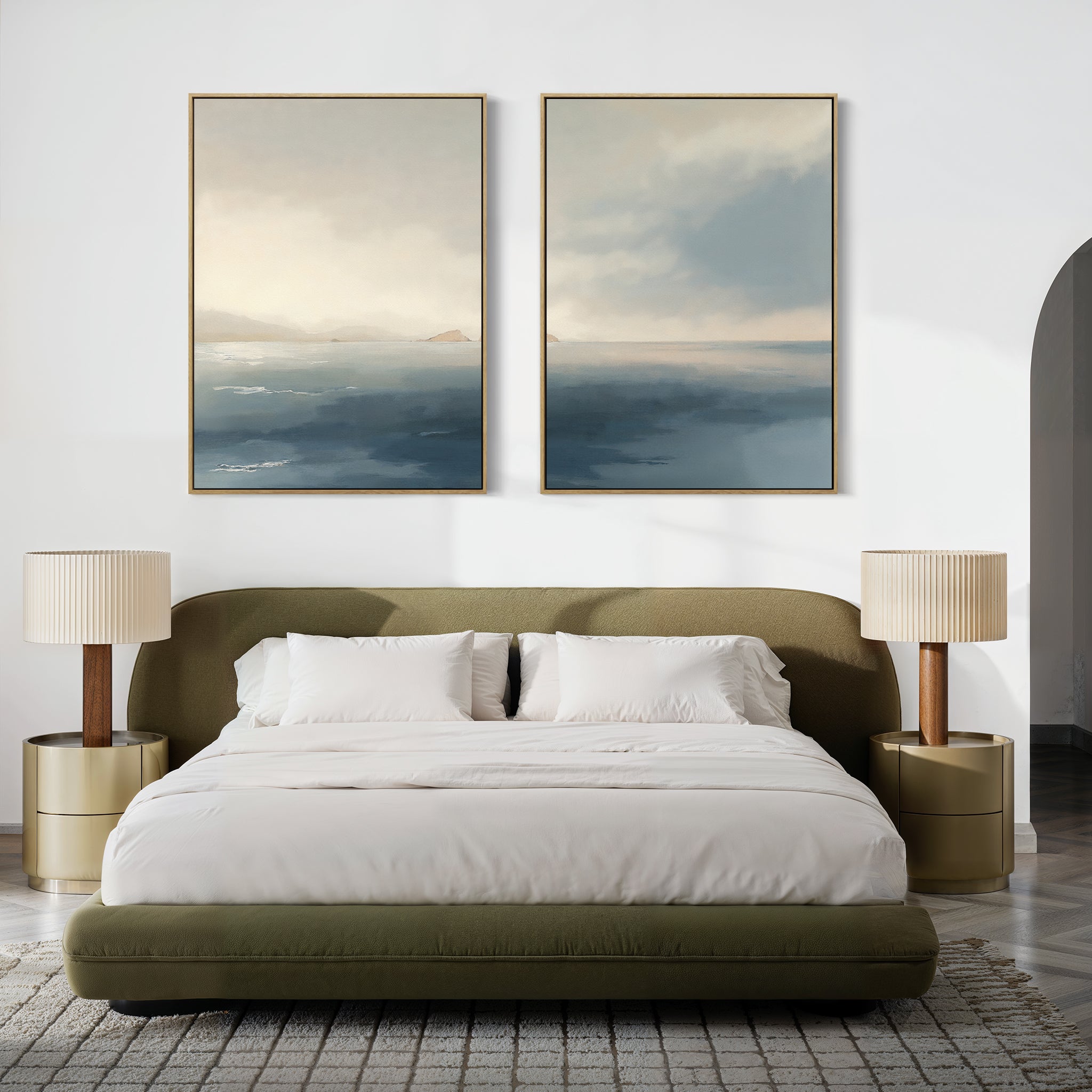 A modern bedroom features a green upholstered bed with white bedding, two gold nightstands with pleated lamps, and "Distant Isles - Set of 2" canvas prints above the bed. A textured rug adds warmth to the floor.