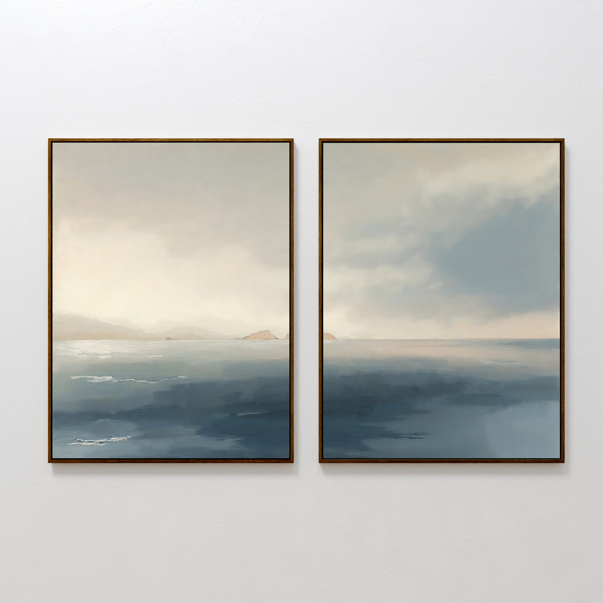 The "Distant Isles - Set of 2" features framed paintings of a tranquil seascape with soft blue and beige hues, gentle waves, and distant landforms beneath a light-filled sky, adding serene atmosphere to any space.