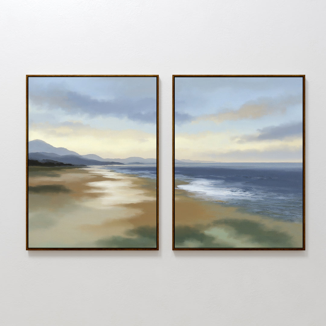 The Distant Shores - Set of 2 features framed paintings of a serene coastal panorama with a sandy beach, calm sea, and distant hills under a softly lit, cloudy sky.