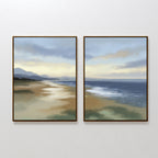 The Distant Shores - Set of 2 features framed paintings of a serene coastal panorama with a sandy beach, calm sea, and distant hills under a softly lit, cloudy sky.