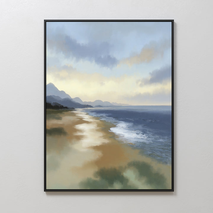 The Distant Shores Canvas Art - Vertical is a framed print featuring a serene coastal panorama with gentle waves, sandy shore, distant mountains, and a cloudy sky reflecting soft light.