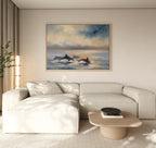 A modern living room features a cream sectional, light wood coffee table, and "Dolphin Pod at Sunset Canvas Art - Horizontal" on the beige wall. Natural light enters from the left.