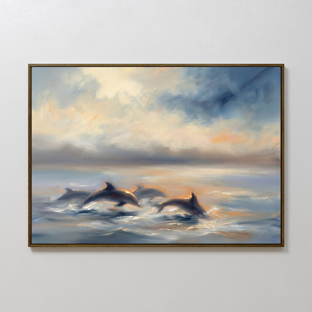 The Dolphin Pod at Sunset Canvas Art - Horizontal features dolphins swimming beneath a cloudy sky with warm, tranquil blue, white, and orange tones. This framed coastal wall art brings serene ocean beauty to any room.