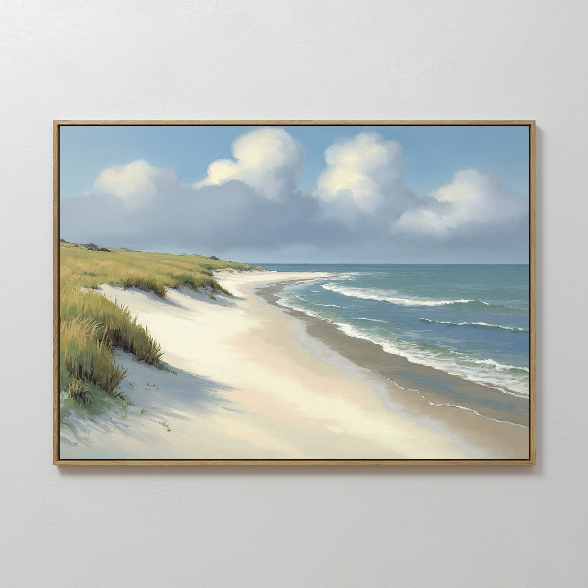 The Dune Whispers Canvas Art - Horizontal, featuring a sandy beach with grassy dunes, gentle waves, and a partly cloudy sky, is displayed against a plain white wall.