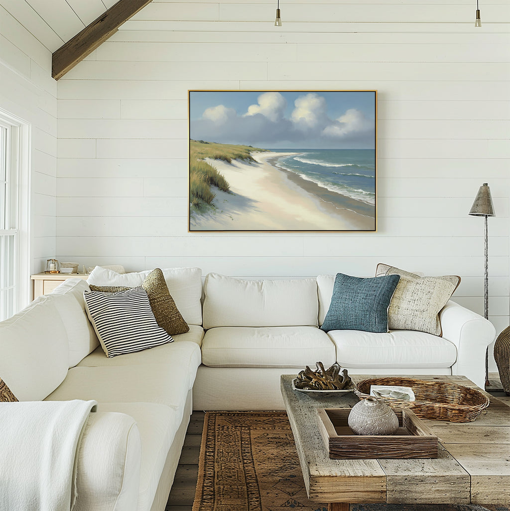 A bright, airy living room with white shiplap walls, a large white sectional sofa, rustic wooden coffee table, and the Dune Whispers Canvas Art - Horizontal of a coastal landscape displayed above the sofa.