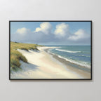The Dune Whispers Canvas Art - Horizontal showcases a sandy beach with grassy dunes, gentle waves, and a blue sky with clouds, adding serene coastal charm to any space when hung on a plain white wall.
