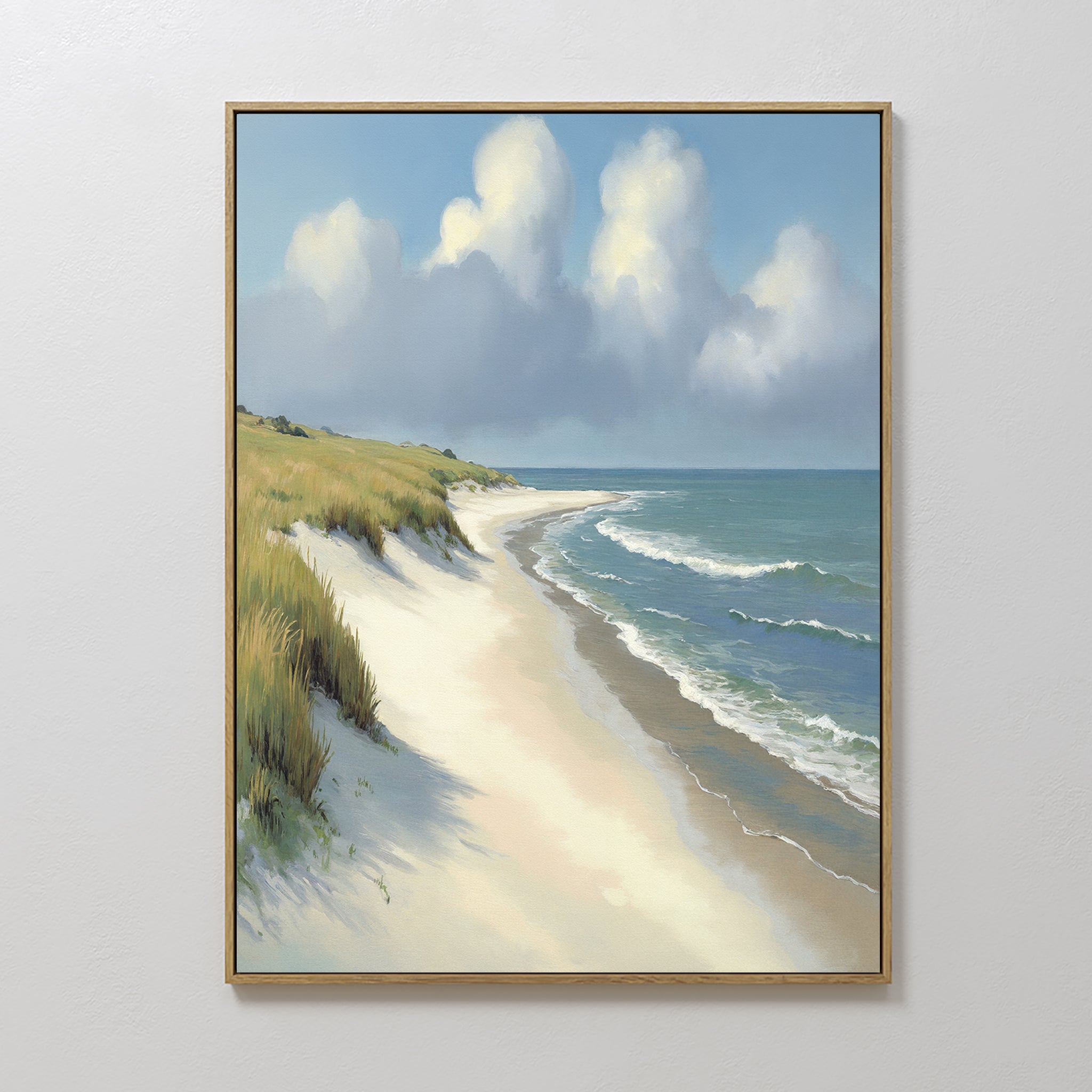 The Dune Whispers Canvas Art - Vertical showcases a serene beach with gentle waves, white sand, grassy dunes on the left, and a cloud-filled blue sky—ideal coastal wall decor for light-colored interiors.