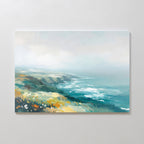 Bring Nordic Park charm to your home with the Emerald Cliffs Canvas Art - Horizontal, featuring blue ocean waves, rugged cliffs, and fields of yellow and green wildflowers beneath a misty sky.