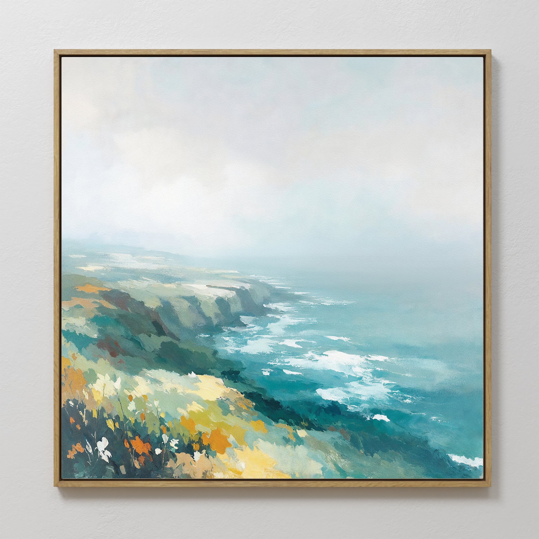 The Emerald Cliffs Canvas Art - Square features a framed coastal landscape with wildflowers and ocean waves beneath a misty sky, painted in soft blue, green, yellow, and white brushstrokes.