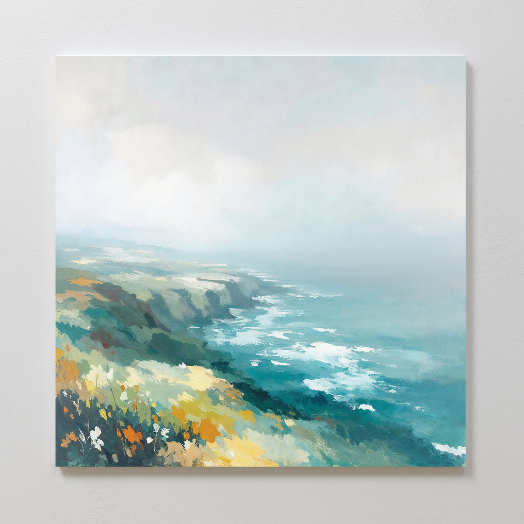The Emerald Cliffs Canvas Art - Square features a misty coastal landscape with waves crashing against emerald cliffs and wildflowers, fading into a foggy sky in soft blues, greens, and yellows.