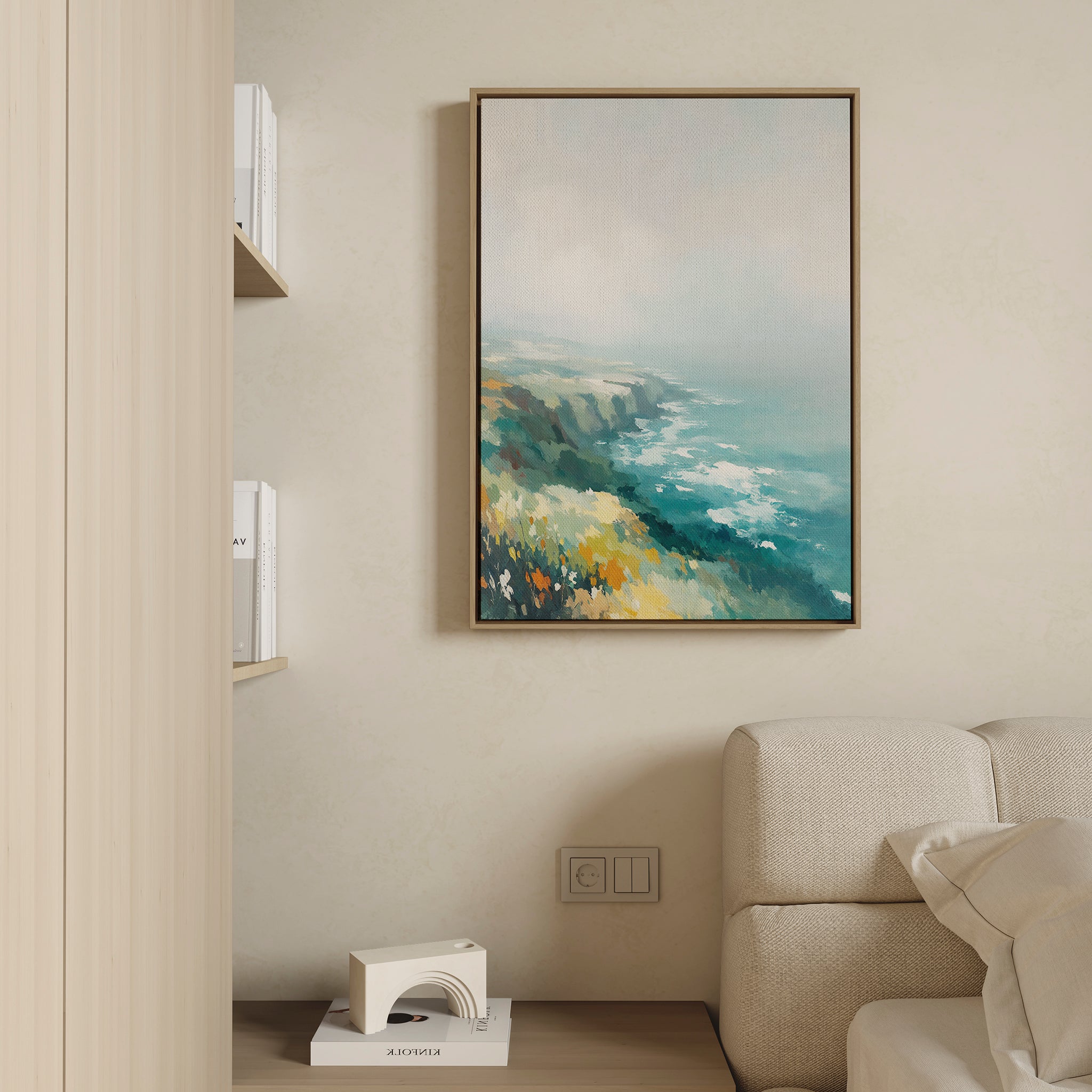 The Emerald Cliffs Canvas Art - Vertical hangs above a light sofa on a beige wall in this modern, minimalist living room, with nearby shelves displaying white books and a small decorative item.