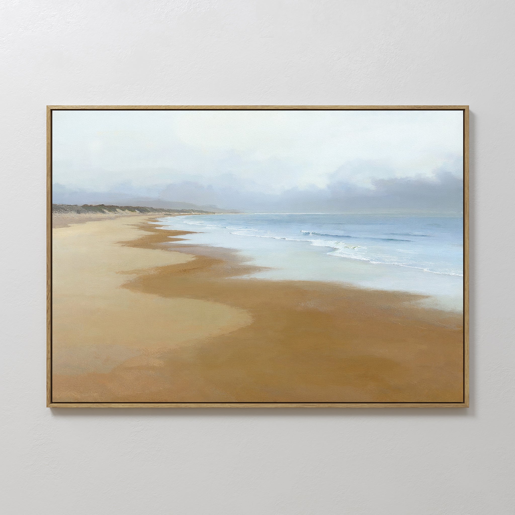 The Endless Shoreline Canvas Art - Horizontal features a calm beach with soft brown sand and gentle waves beneath a cloudy sky, creating serene wall art that’s perfect for any space.