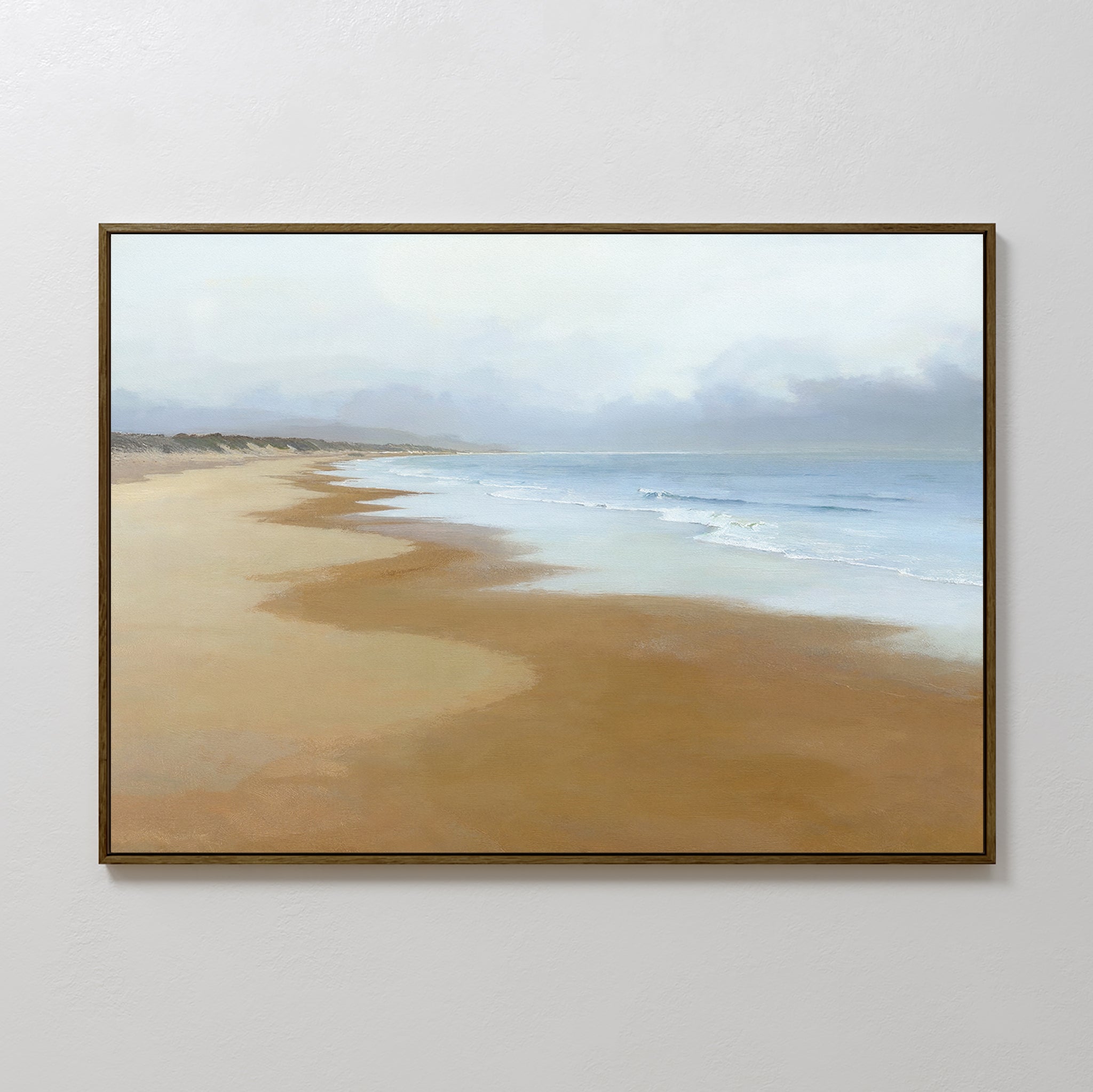 The Endless Shoreline Canvas Art - Horizontal features a serene coastal scene of gentle waves on a sandy beach beneath a cloudy sky, with soft, muted colors creating a calm and peaceful wall art accent.