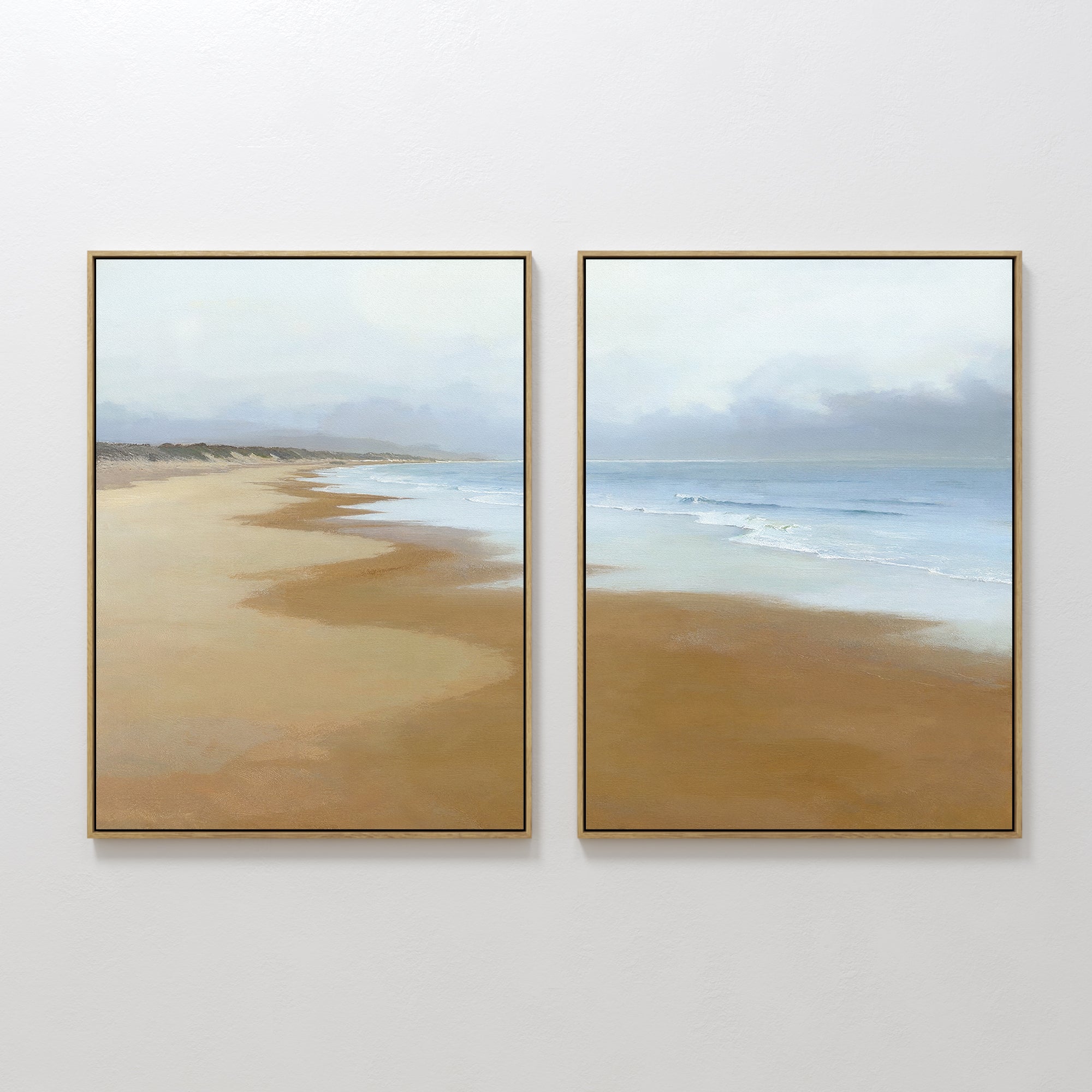 The Endless Shoreline - Set of 2 features framed coastal canvas prints with minimalist sandy beaches and gentle waves under a cloudy sky, bringing Nordic Park-inspired tranquility to your wall.