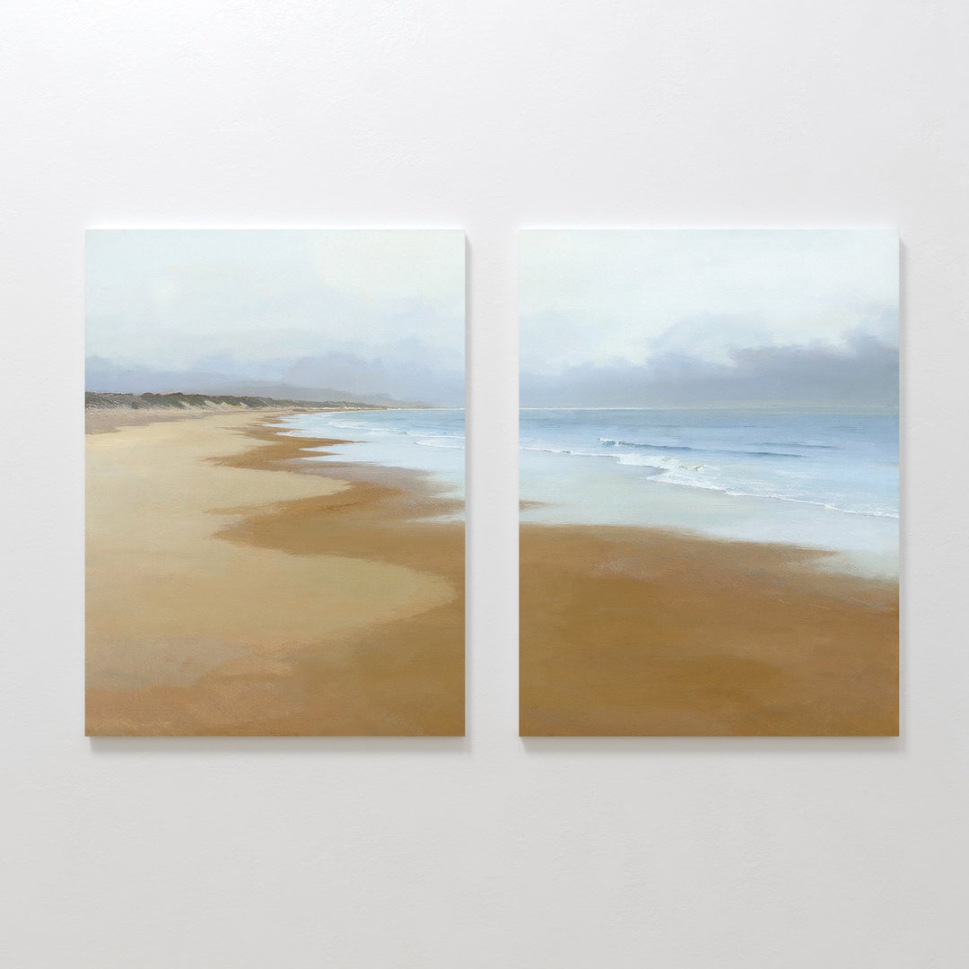 Endless Shoreline - Set of 2 features side-by-side wall art with a tranquil beach, golden sand, gentle waves, a cloudy sky, and a curving shore—bringing peaceful coastal beauty to any space.