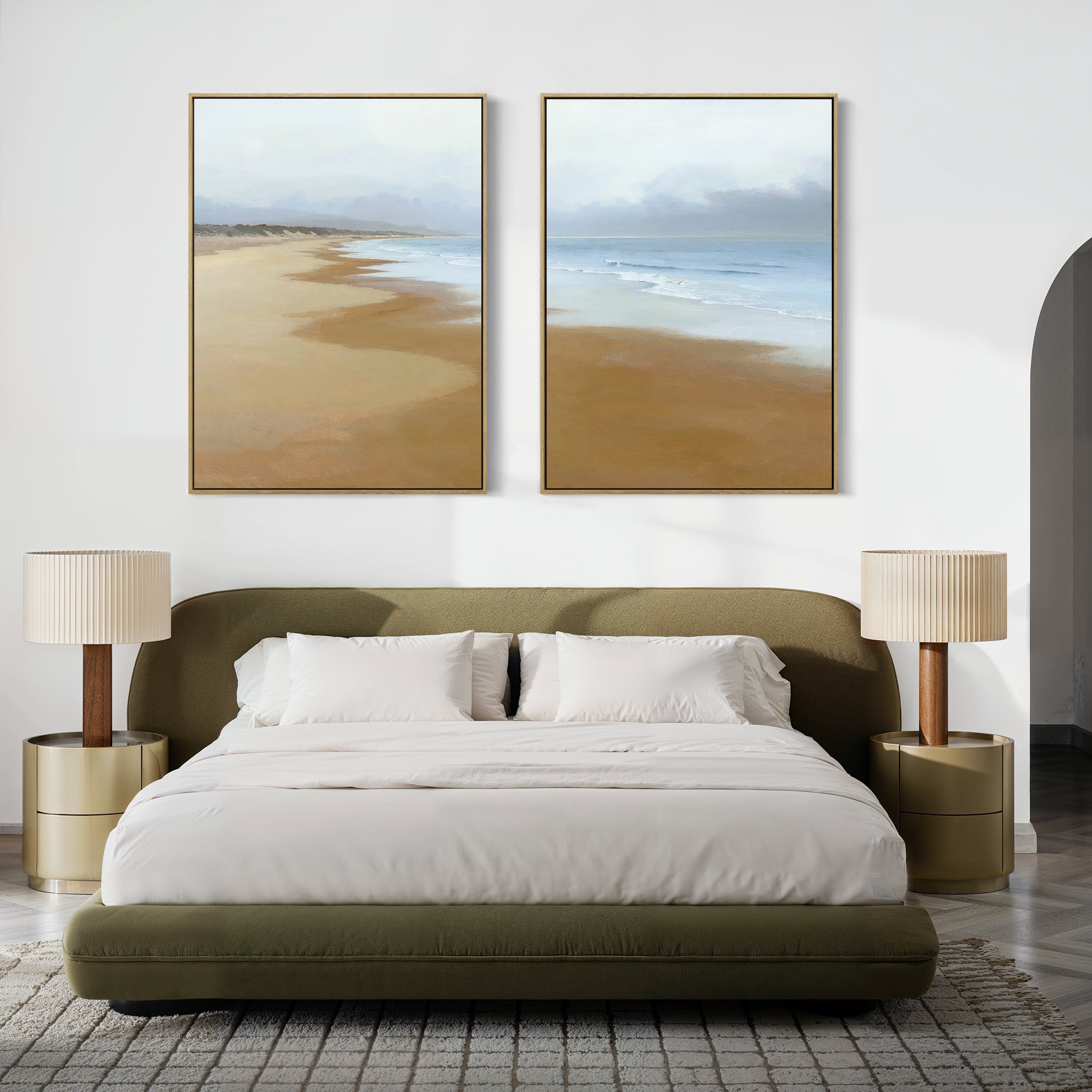 A modern bedroom featuring a green upholstered bed with white bedding, gold nightstands, and serene wall art—Endless Shoreline - Set of 2 large coastal canvas prints depicting a beach and ocean above the bed.