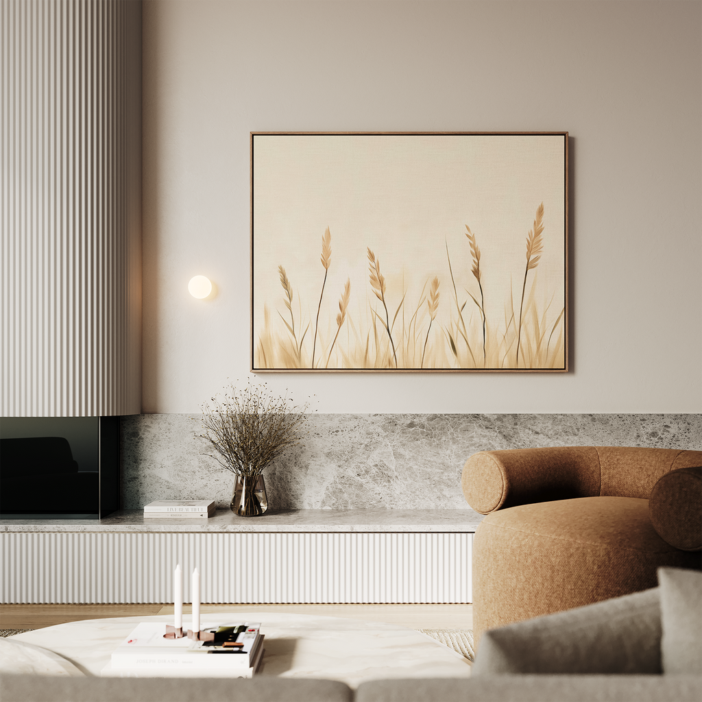 A modern living room featuring a light brown sofa, marble surfaces, neutral-toned decor in soft lighting, and the Whispering Reeds Canvas Art framed on the wall above a minimalist vase with dried plants.