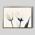 The Ethereal Blooms Canvas Art - Horizontal features two pale, abstract tulips with dark stems on a light background—its minimalist style brings elegance to modern living rooms, especially when displayed on a neutral gray wall.