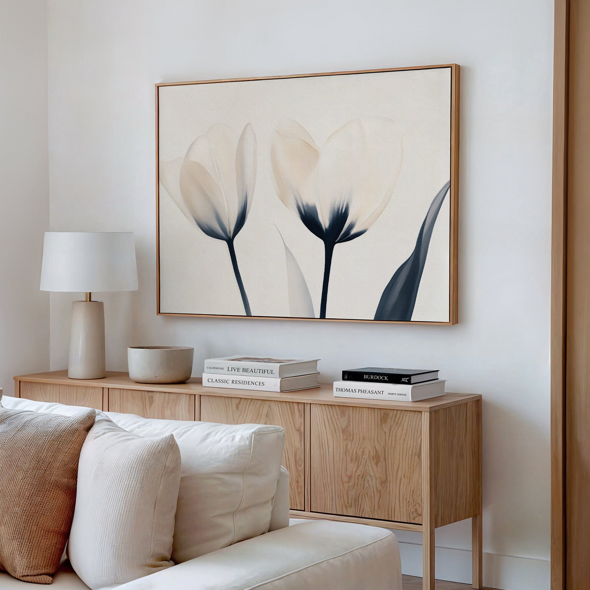A minimalist living room featuring a light wood sideboard, white lamp, stacked books, ceramic bowl, and the Ethereal Blooms Canvas Art - Horizontal above—perfect inspiration for modern Nordic Park-style spaces.