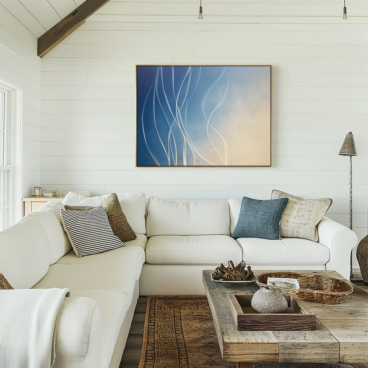 A bright, cozy living room with white shiplap walls, a white sectional with assorted pillows, a rustic wooden coffee table, and the Ethereal Lines Canvas Art - Horizontal above the sofa—ideal for modern and Nordic Park-inspired decor fans.