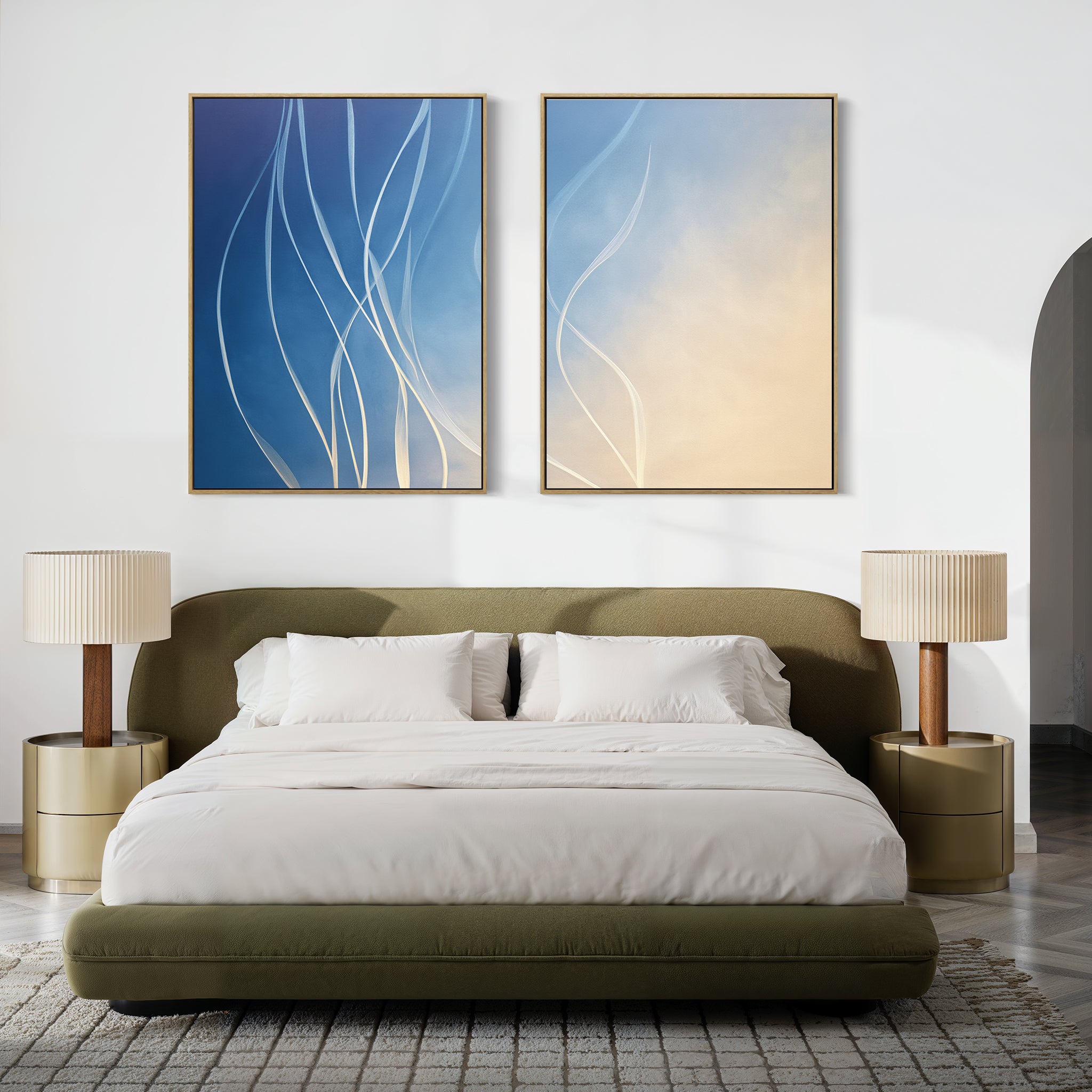 A modern bedroom with an olive green bed, white bedding, gold nightstands with pleated lamps, and Ethereal Lines - Set Of 2 artworks above the headboard. A textured rug covers the floor.