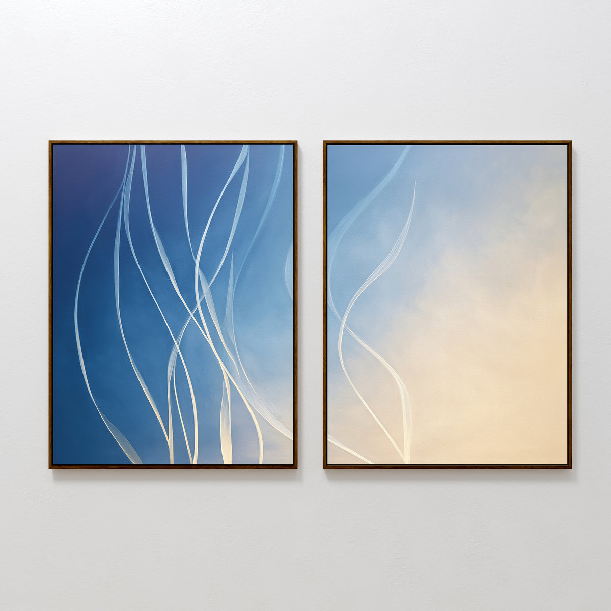 The Ethereal Lines - Set Of 2 features abstract prints with flowing white lines—one on blue, the other on a cream-to-pale blue gradient. Stylish and modern, they add a touch of Nordic Park elegance to any living room wall.