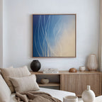 A minimalist living room with a neutral sofa, textured pillows, and a wooden sideboard styled with vases and books. Above, the Ethereal Lines Canvas Art - Square adds modern flair as sunlight filters through soft window curtains.