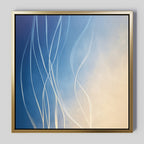 The Ethereal Lines Canvas Art - Square features flowing white lines over a blue-to-beige gradient, framed in simple gold—a modern abstract piece perfect for your living room or to add stylish flair to any space.