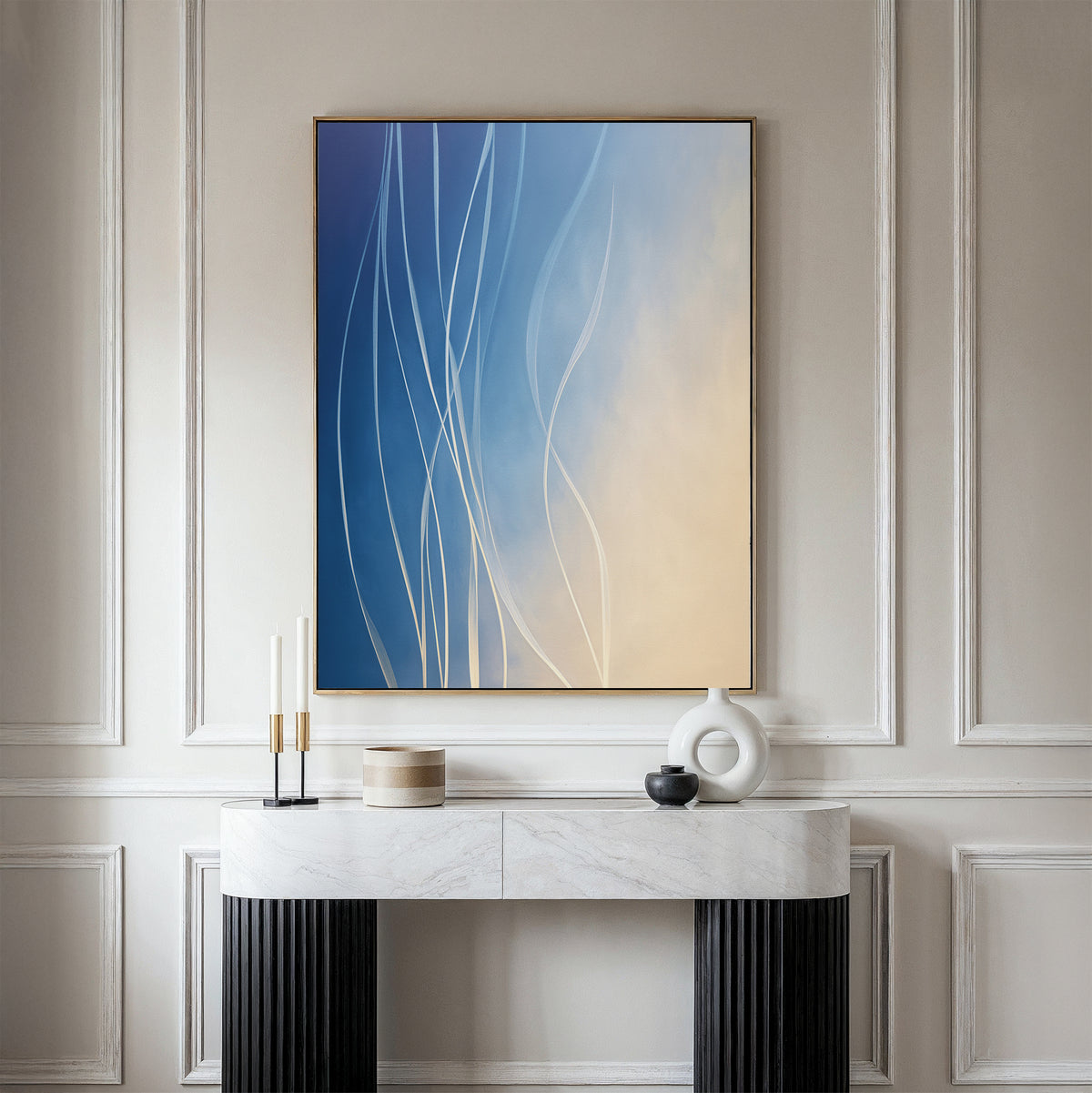 A modern, minimalist console table with black legs and a white marble top sits against a paneled wall. Above it hangs the Ethereal Lines Canvas Art - Vertical, featuring blue and beige gradients—perfect for Nordic Park inspired living room decor.