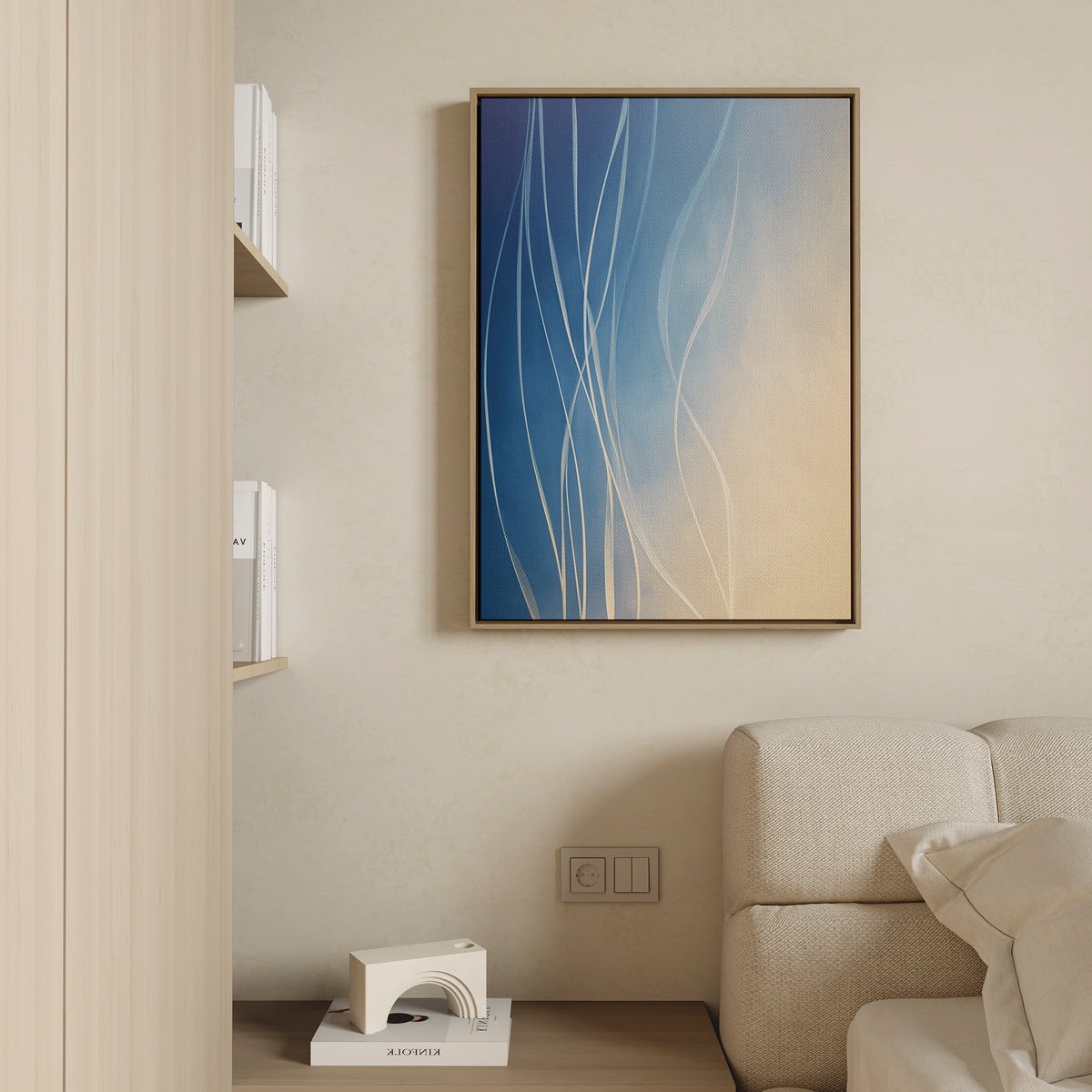 A modern living room corner with a beige sofa, built-in shelves, sculptural decor, and the Ethereal Lines Canvas Art - Vertical in blue and beige—perfect for fans of refined Nordic Park-inspired modern decor.
