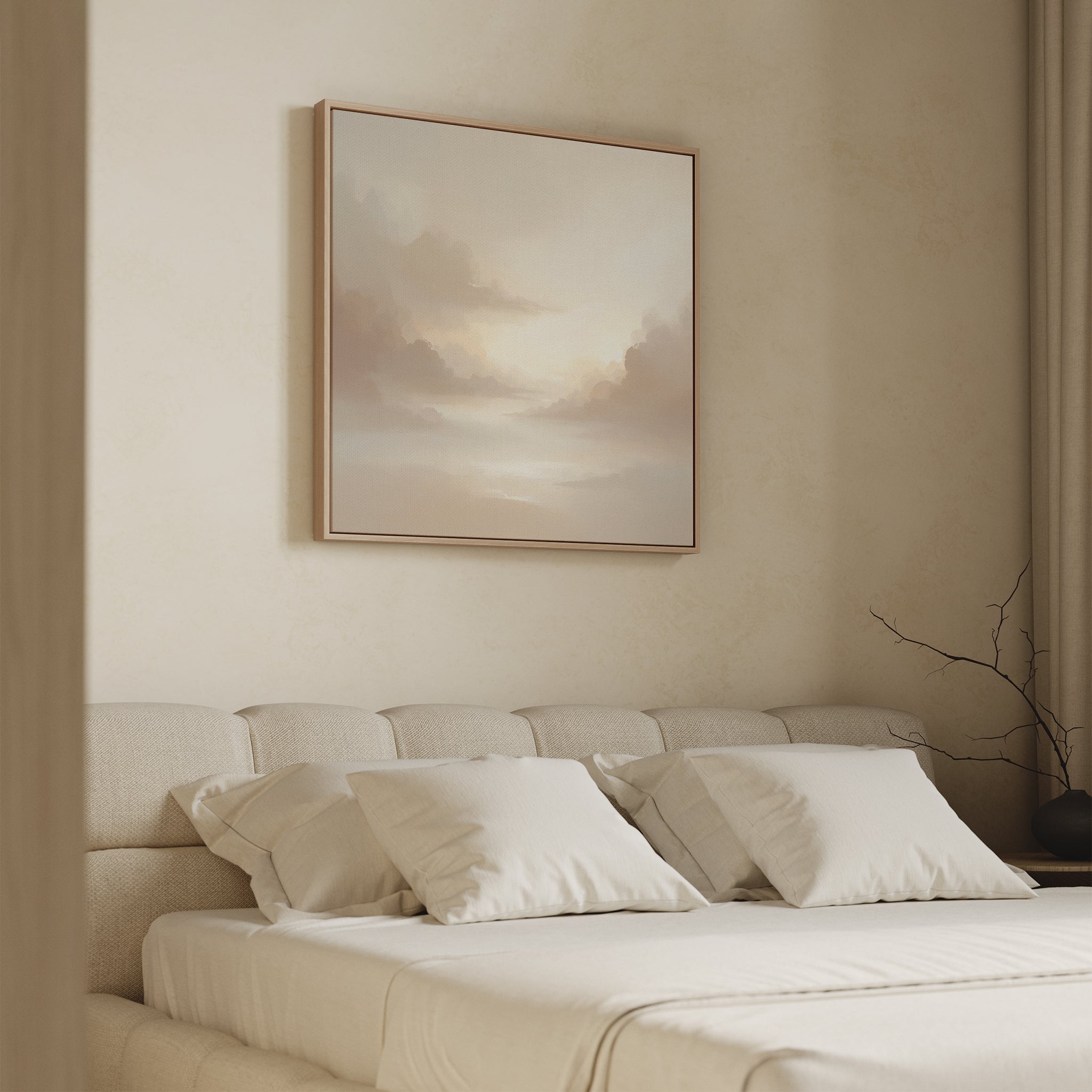 A minimal, serene bedroom features a beige upholstered bed with white bedding and pillows. The Ethereal Veil Canvas Art - Square hangs above the bed, while a bare branch sits in a vase on the bedside table.