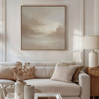 A modern living room with a beige sofa, neutral pillows, a vase of dried flowers, a table lamp, and the Ethereal Veil Canvas Art - Square featuring soft clouds above the couch. Sunlight gently illuminates the serene space.
