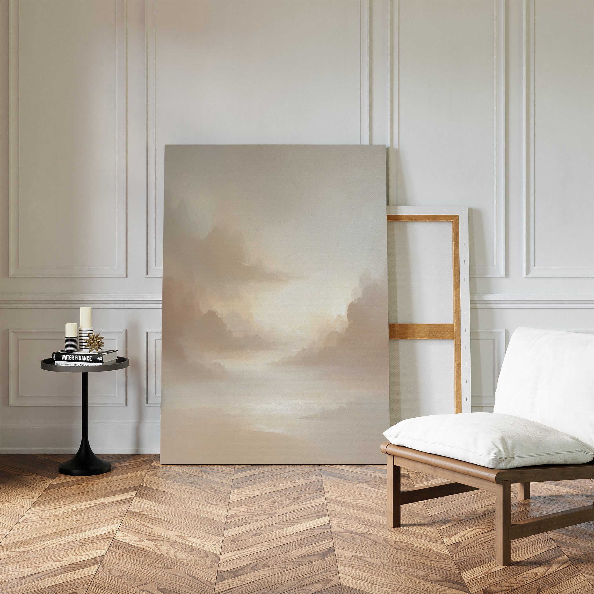 A minimalist room with herringbone wood floors, a white cushioned chair, and a round black side table with candles. The Ethereal Veil Canvas Art - Vertical leans against the paneled white wall.