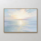 The Ethereal Waters Canvas Art - Horizontal is a framed coastal artwork depicting a serene seascape at sunrise or sunset, with soft pastel hues, gentle clouds, and sunlight reflecting on calm water.