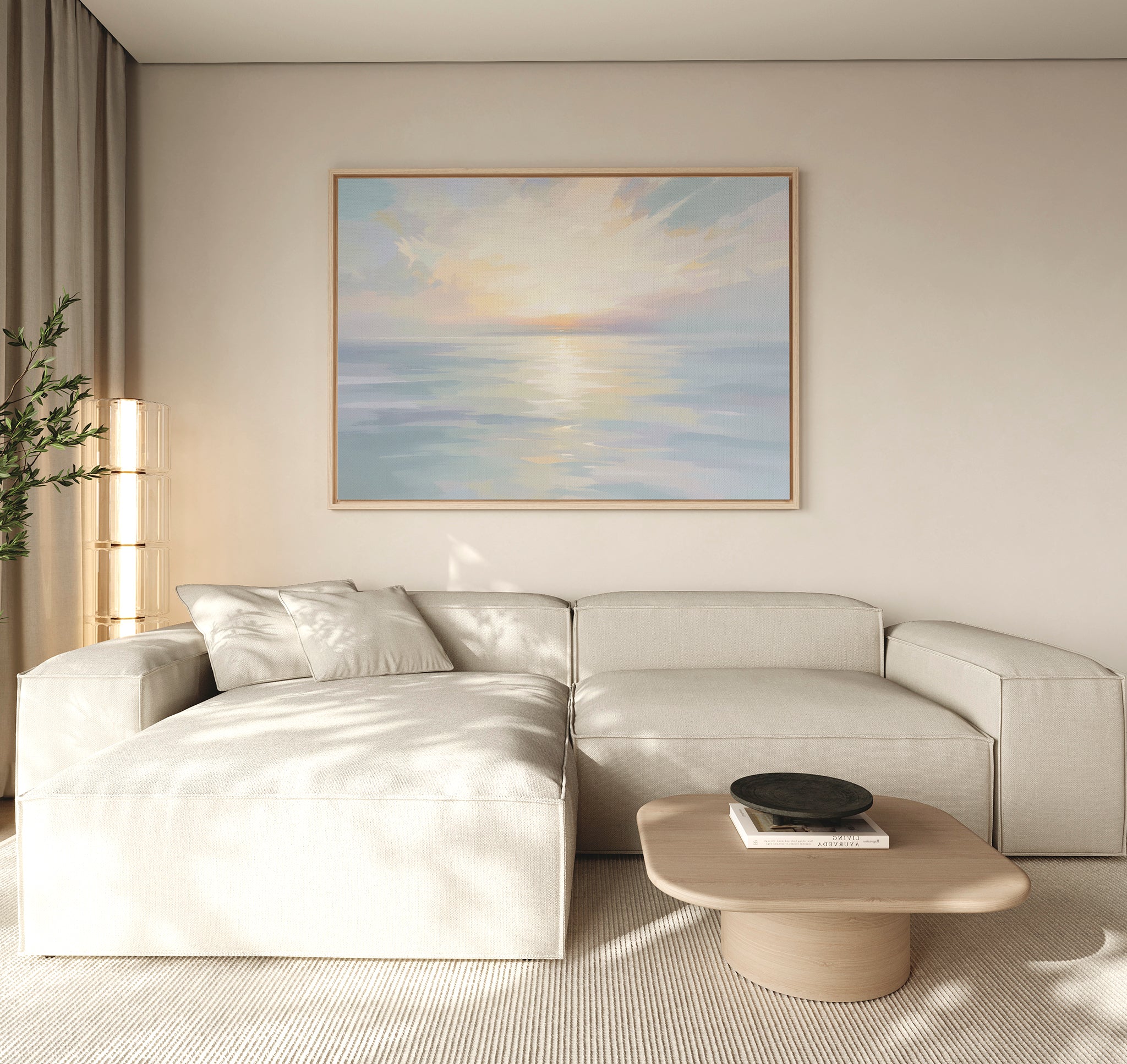 A modern living room features a light beige sectional sofa, wooden coffee table with black bowl, tall plant, and serene wall art—Ethereal Waters Canvas Art - Horizontal—depicting a tranquil seascape in soft pastel colors.