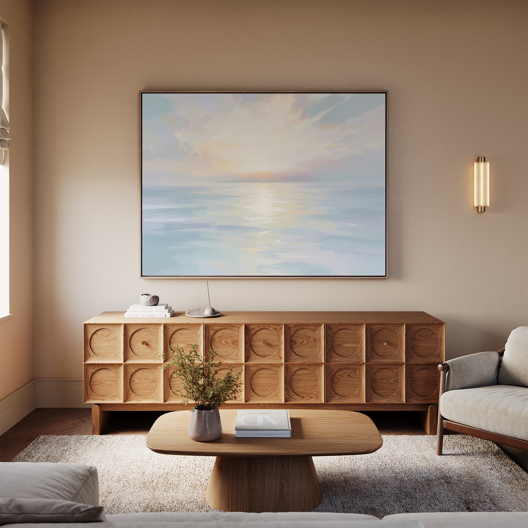 A cozy living room in neutral tones features a light wood coffee table, patterned wood sideboard, and the "Ethereal Waters Canvas Art - Horizontal" above a beige sofa. A soft rug and vase of flowers complete the inviting space.