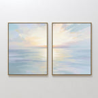 The Ethereal Waters - Set of 2 features framed abstract paintings of tranquil seascapes in soft pastel blues, pinks, and yellows with sunrise or sunset reflections, displayed side by side for serene wall decor.