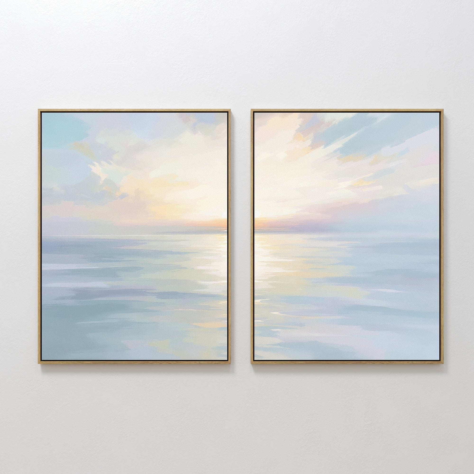 The Ethereal Waters - Set of 2 features framed abstract paintings of tranquil seascapes in soft pastel blues, pinks, and yellows with sunrise or sunset reflections, displayed side by side for serene wall decor.